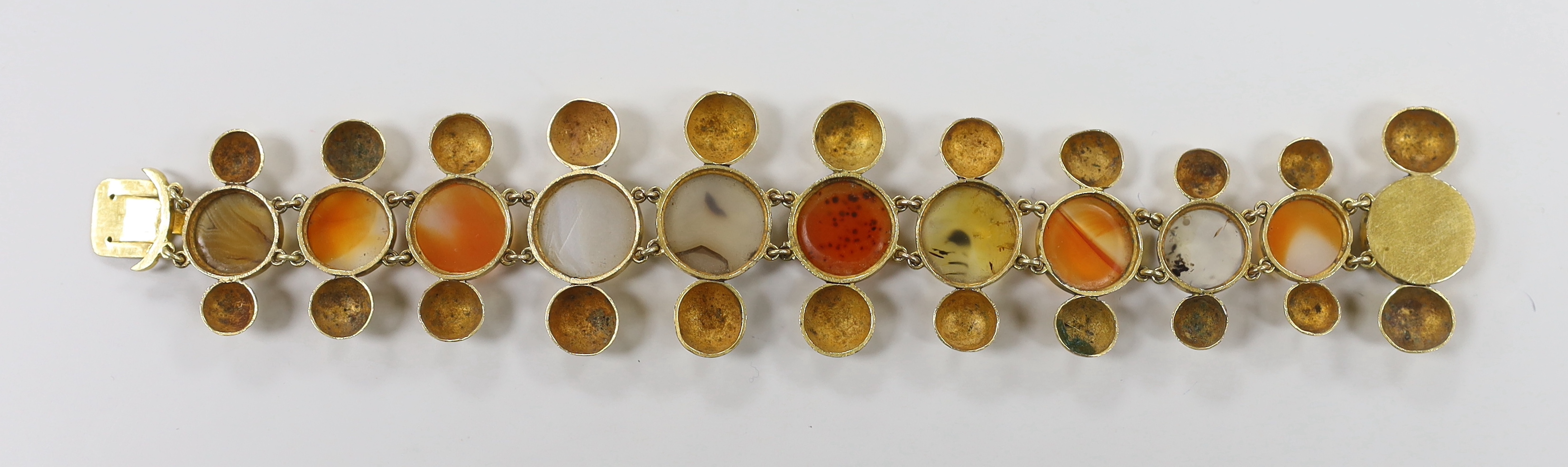 A Victorian pinchbeck and graduated eleven stone cabochon agate set bracelet, 18.5cm.